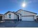 Single-story house with a two-car garage and neutral color scheme at 15429 W Hackamore Dr, Surprise, AZ 85387