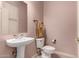 Clean bathroom with pedestal sink, toilet and a mirror at 15639 E Palomino Blvd, Fountain Hills, AZ 85268