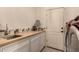 Laundry room with butcher block countertop, cabinets and sink at 15639 E Palomino Blvd, Fountain Hills, AZ 85268