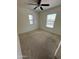 Light-filled bedroom featuring neutral carpet, a ceiling fan, and natural light from the windows at 16405 W Latham St, Goodyear, AZ 85338