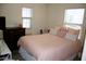 This bedroom features a bed, dresser, and two windows with blinds at 16405 W Latham St, Goodyear, AZ 85338