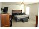 This bedroom features a ceiling fan, mounted tv, and bedside tables at 16405 W Latham St, Goodyear, AZ 85338