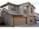 Two story exterior featuring a well maintained attached garage and desert landscaping at 16405 W Latham St, Goodyear, AZ 85338