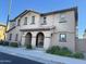 Two-story home with beautiful archway, desert landscaping, and neutral stucco facade at 16405 W Latham St, Goodyear, AZ 85338