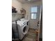 This spacious laundry room includes a modern washer and dryer set at 16405 W Latham St, Goodyear, AZ 85338