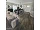 Open concept living and dining area with modern furnishings and hardwood floors at 16405 W Latham St, Goodyear, AZ 85338