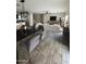 Spacious living room with hardwood floors, modern furnishings, and an open floor plan at 16405 W Latham St, Goodyear, AZ 85338
