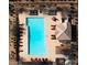 Aerial view of pool with lounge chairs and cabana at community center at 16405 W Latham St, Goodyear, AZ 85338