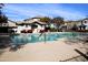 Community pool with lounge chairs, clubhouse and clear blue water at 16405 W Latham St, Goodyear, AZ 85338