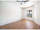 Bedroom with wood-look floors, a ceiling fan, and stunning mountain views at 16439 E Nicklaus Dr, Fountain Hills, AZ 85268