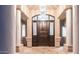 Elegant entryway with columns and a grand wooden door at 16439 E Nicklaus Dr, Fountain Hills, AZ 85268