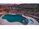 Aerial view of a freeform pool and spa with a mountain backdrop at 16439 E Nicklaus Dr, Fountain Hills, AZ 85268