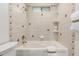 Clean bathroom with a bathtub and tiled shower walls at 17052 N 36Th Ct, Phoenix, AZ 85032