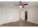 Bedroom with double door closet and wood-look floors at 17052 N 36Th Ct, Phoenix, AZ 85032