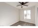 Bright bedroom featuring wood-look floors and a ceiling fan at 17052 N 36Th Ct, Phoenix, AZ 85032