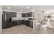 Modern kitchen with dark cabinetry and quartz countertops at 17052 N 36Th Ct, Phoenix, AZ 85032