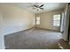 Spacious bedroom with carpet and access to backyard at 17597 W Aster Dr, Surprise, AZ 85388