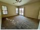 Bedroom with carpet flooring and sliding glass doors at 17597 W Aster Dr, Surprise, AZ 85388