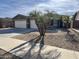 House with three-car garage and palm trees at 17597 W Aster Dr, Surprise, AZ 85388