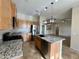 Kitchen boasts granite counters and a large island at 17597 W Aster Dr, Surprise, AZ 85388