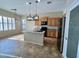 Kitchen with island, granite counters, and stainless steel appliances at 17597 W Aster Dr, Surprise, AZ 85388