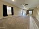 Spacious living room with neutral carpeting and large windows at 17597 W Aster Dr, Surprise, AZ 85388