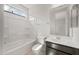 Bright bathroom featuring a shower and tub, white toilet, vanity and large mirror at 17638 W Rancho Dr, Litchfield Park, AZ 85340