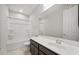 A well lit bathroom with vanity sink, large mirror, and a shower-tub combo at 17638 W Rancho Dr, Litchfield Park, AZ 85340