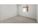 An airy bedroom featuring neutral colored carpet, white trim and a window at 17638 W Rancho Dr, Litchfield Park, AZ 85340