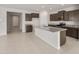 Stylish kitchen features a granite island, stainless steel appliances, and dark wood cabinets at 17638 W Rancho Dr, Litchfield Park, AZ 85340