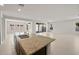 Bright open-concept kitchen with granite island flowing into spacious living area at 17638 W Rancho Dr, Litchfield Park, AZ 85340