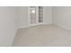 This spacious office features bright white walls, white tile, and glass French doors at 17638 W Rancho Dr, Litchfield Park, AZ 85340