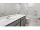 This bathroom features a shower and tub combo, a single sink, and standard fixtures at 17644 W Rancho Dr, Litchfield Park, AZ 85340