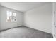 Bedroom featuring gray carpet and a large window offering plenty of natural light at 17644 W Rancho Dr, Litchfield Park, AZ 85340