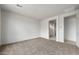 Bright bedroom featuring neutral carpet, a walk-in closet, and an en-suite bathroom at 17644 W Rancho Dr, Litchfield Park, AZ 85340