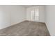 The bedroom boasts gray carpeting and glass French doors to provide a bright space at 17644 W Rancho Dr, Litchfield Park, AZ 85340