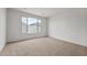 Comfortable bedroom with neutral carpet and a large window at 17644 W Rancho Dr, Litchfield Park, AZ 85340