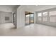 Spacious living room with tile floors, large windows, and sliding glass doors leading to the patio at 17644 W Rancho Dr, Litchfield Park, AZ 85340