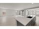 Open-concept kitchen and living area with tile flooring and lots of natural light at 17644 W Rancho Dr, Litchfield Park, AZ 85340