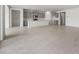 Expansive living room showcasing tile flooring and a kitchen island with gray cabinetry at 17644 W Rancho Dr, Litchfield Park, AZ 85340