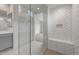 Detailed shower with neutral tile and a glass partition at 17644 W Rancho Dr, Litchfield Park, AZ 85340