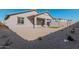 Backyard with gravel, artificial grass, and some plants at 18411 W Monte Lindo Ln, Surprise, AZ 85387