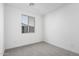 Bright and airy bedroom with grey carpet and large window at 18411 W Monte Lindo Ln, Surprise, AZ 85387