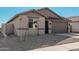 Single-story home with neutral exterior and a two-car garage at 18411 W Monte Lindo Ln, Surprise, AZ 85387