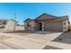 Single-story home with a two-car garage and neutral color scheme at 18411 W Monte Lindo Ln, Surprise, AZ 85387