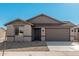 Newly built home with neutral exterior and two-car garage at 18411 W Monte Lindo Ln, Surprise, AZ 85387