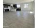 Open living area with spacious layout and neutral-toned tile flooring at 18411 W Monte Lindo Ln, Surprise, AZ 85387