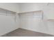 Spacious walk-in closet with double hanging rods at 18411 W Monte Lindo Ln, Surprise, AZ 85387