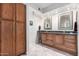 Bathroom boasts double sinks and wood cabinets at 19098 N 97Th Ln, Peoria, AZ 85382