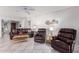 Living room with leather armchairs, coffee table, and tiled floors at 19098 N 97Th Ln, Peoria, AZ 85382